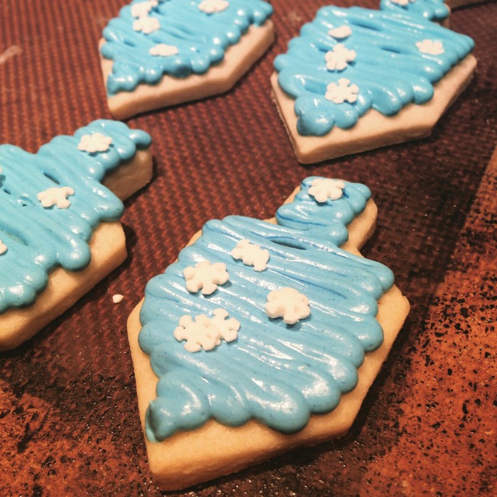 Dreidel sugar cookies with blue royal icing and white snowflakes