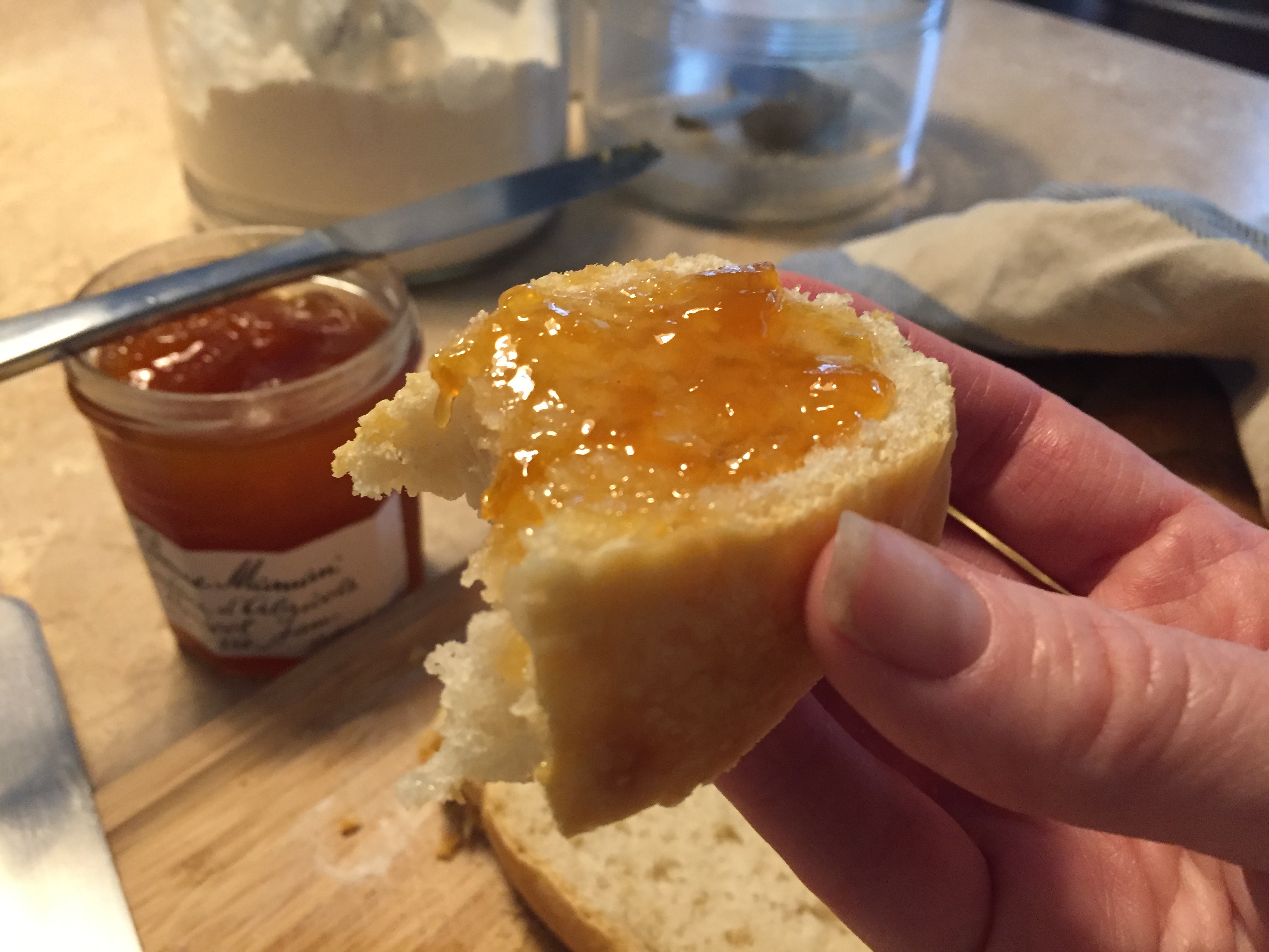 A slice of sourdough slathered with apricot jam